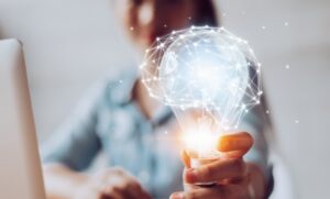 Hand Holding Lightbulb with abstract datapoint illustration