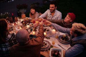 Group toasting around a dinner table