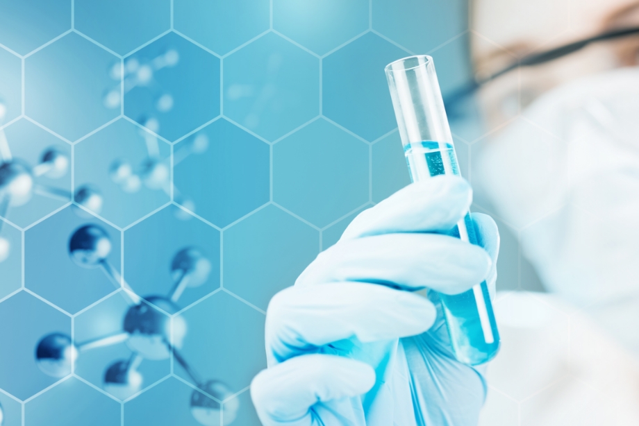 Close up of glove in lab holding test tube