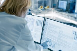 Technician reviewing data on monitors