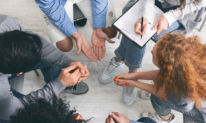 Birds eye view of group of individuals engaged in a discussion in a clinical setting