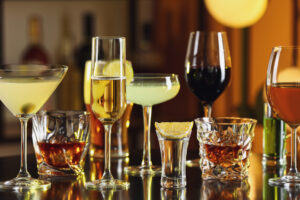 Different Alcohol Drinks On Table In Bar